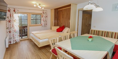 Pensionen - Art der Pension: Privatzimmervermietung - Leogang - Wohnzimmer mit ausgeklapptem Doppelbett von Flexinno - Urlaubsparadies Liebmannhof